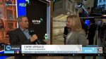 Chris Versace speaks with a FINTECH.TV host on the NYSE trading floor during Taking Stock, with market screens and the New York Stock Exchange backdrop.