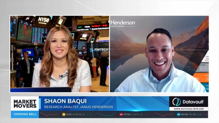 Shaon Baqui sonríe en una entrevista de Market Movers: The Opening Bell junto a una presentadora en la Bolsa de Nueva York, con Janus Henderson detrás.