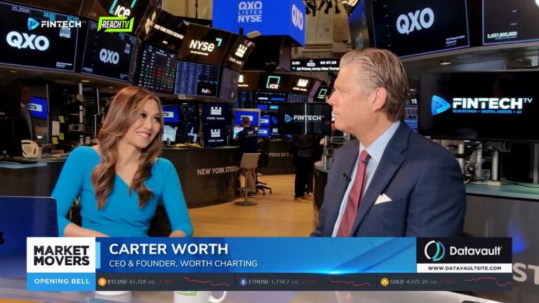 Carter Worth speaks with a host on FINTECH.TV at the New York Stock Exchange, with Market Movers graphics and trading monitors behind them.