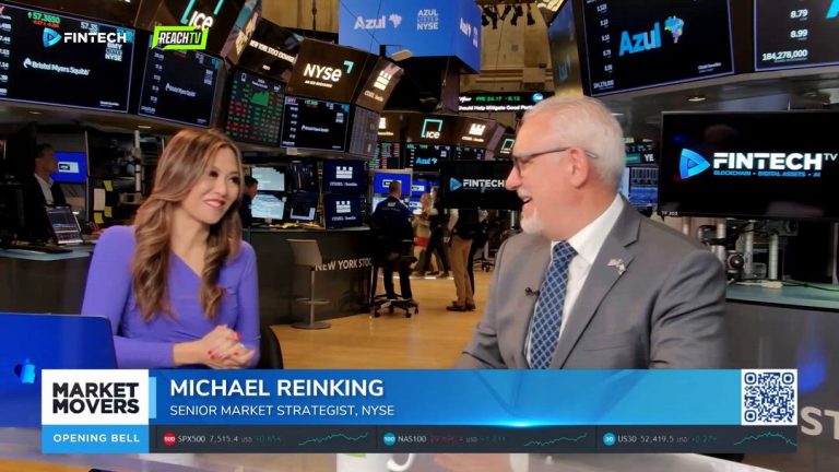 Inside the New York Stock Exchange, Michael Reinking talks with an interviewer as Market Movers and FINTECH.TV graphics appear on the screens behind them.