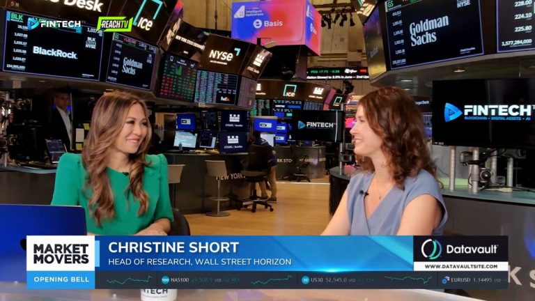 Christine Short talks with a guest on FINTECH.TV’s Market Movers set, framed by trading screens and finance logos.