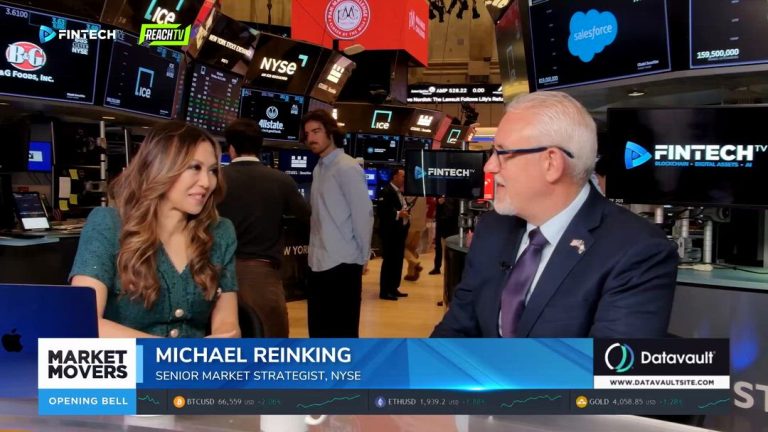 Michael Reinking speaks with a FINTECH.TV host at the NYSE while trading screens and market data glow behind them.
