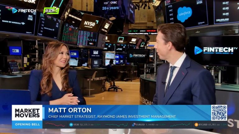 Matt Orton speaks with a presenter on the New York Stock Exchange floor, with FINTECH.TV and market monitors behind them.