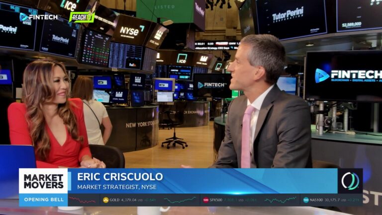 Eric Criscuolo speaks with a host in a red dress on the NYSE trading floor, with FINTECH.TV screens behind them.